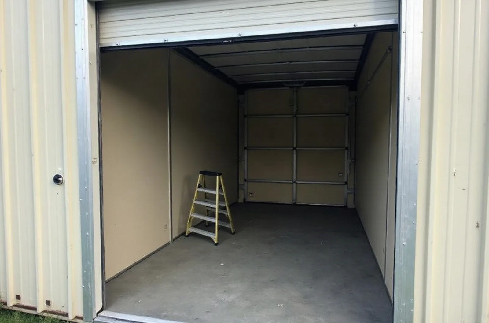 Tall roll-up door on an empty enclosed unit, where door height matters as much as RV storage size