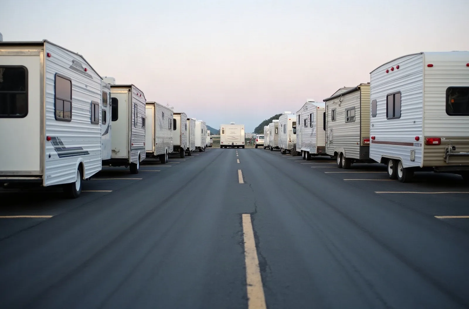 Empty painted back-in space on asphalt, the RV storage size you measure before signing a lease